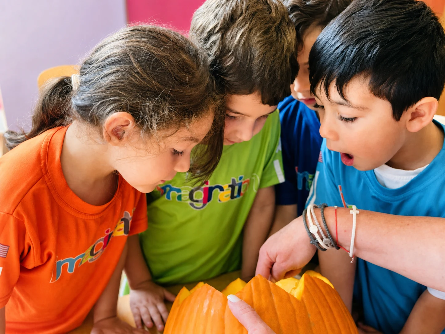 Three children investigating a pumpkin together