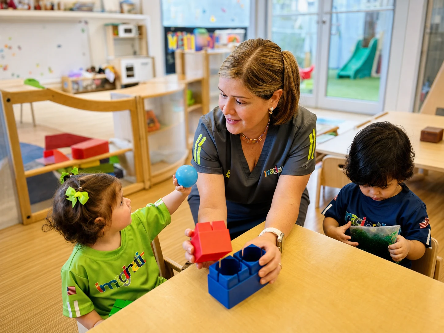 A facilitator supporting children during a hands-on activity
