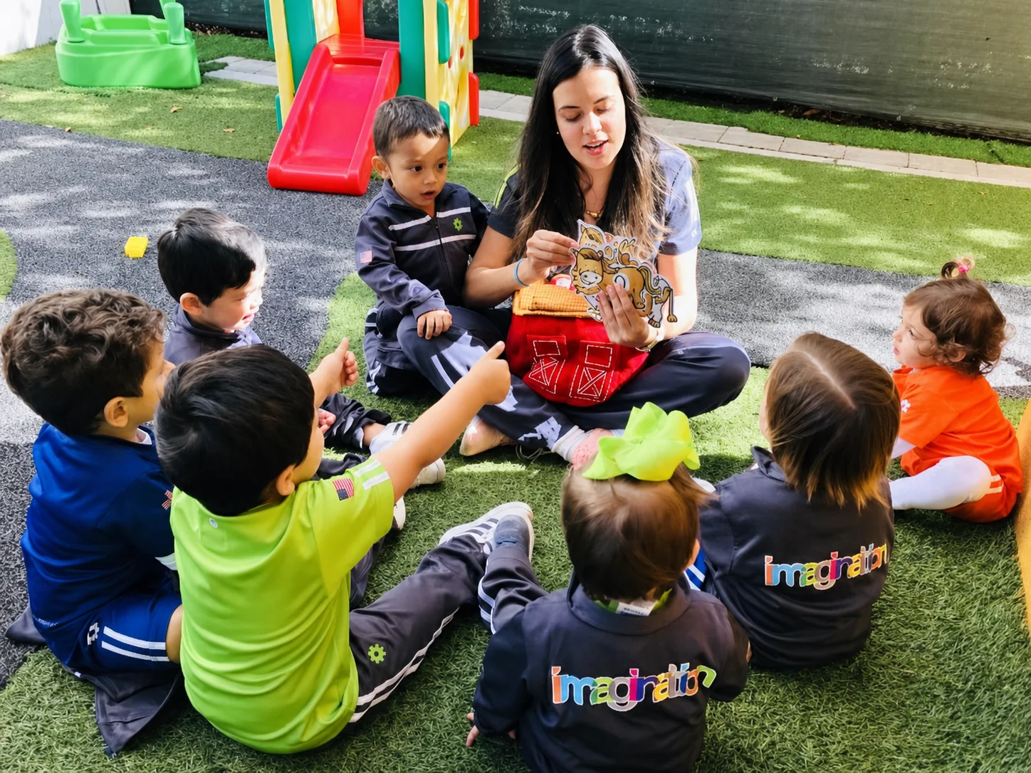 A TIF facilitator leading a Get Together with young children outdoors