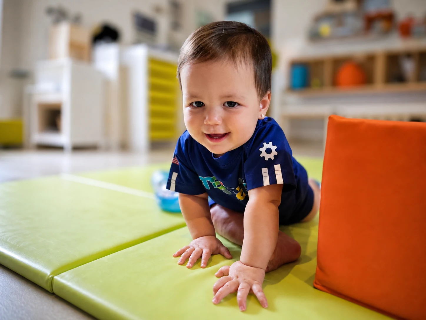 Babies exploring safely with responsive care in the Beginners Playroom